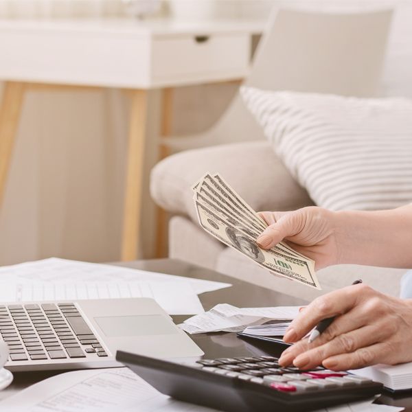 a lady holding money while calculating