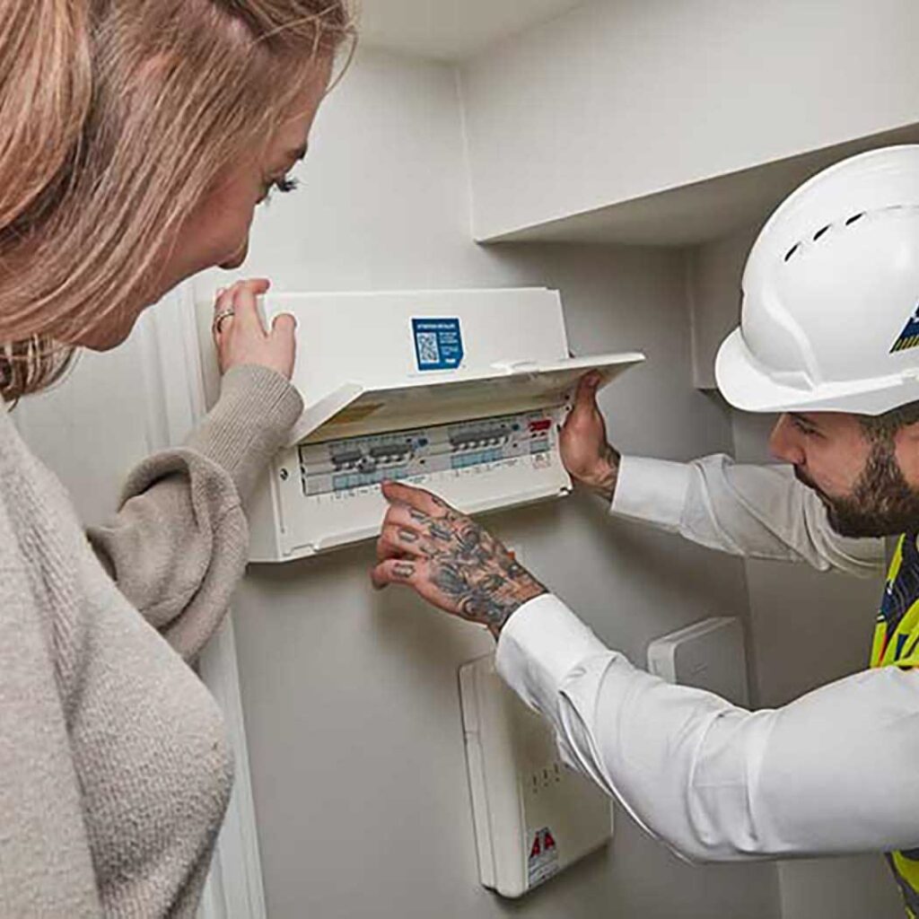 a lady being taught about her electricity meter