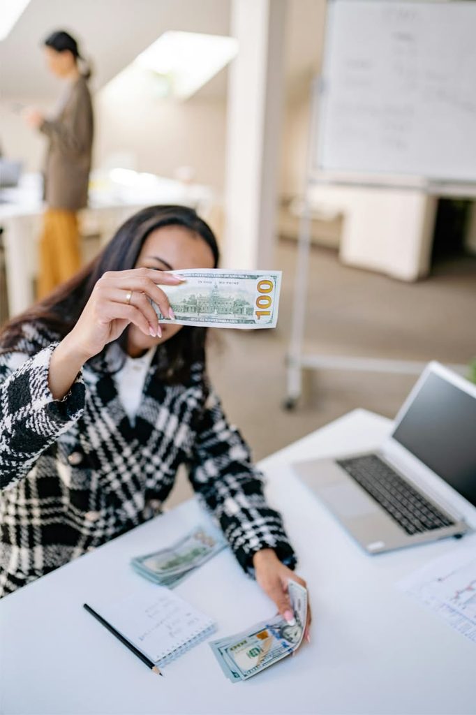 a young lady happy with some cash