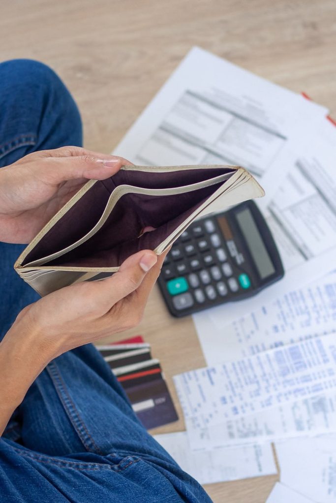 someone sitting with an opened wallet