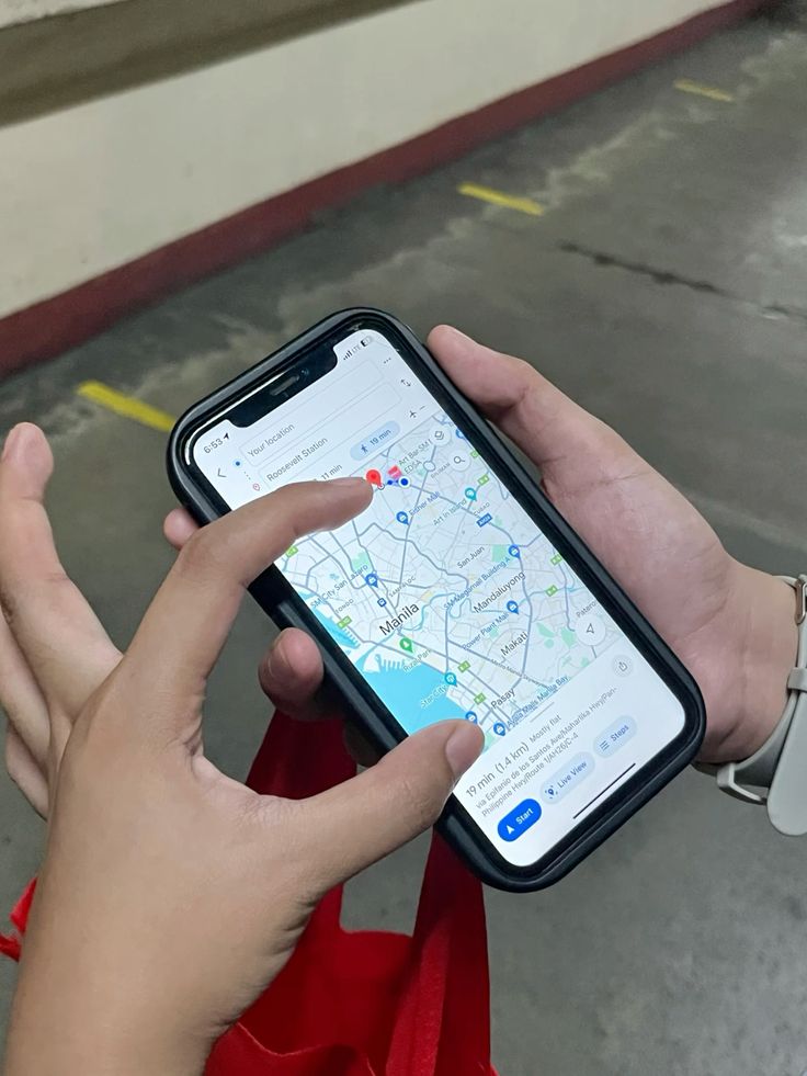 A person using a phone map to check nearby shops, transport stops, pharmacies, and roads