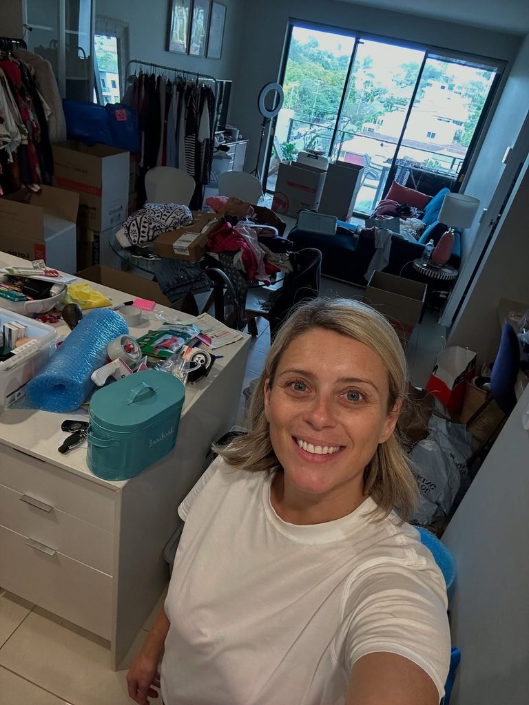 An overwhelmed renter surrounded by too many boxes, shopping bags, furniture samples, and unfinished tasks