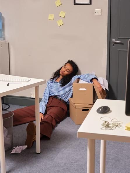 young lady sitting on the floor tired in a new apartment