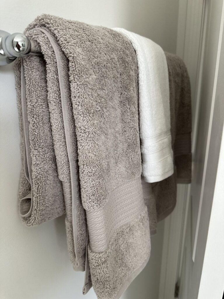 clean bath towels folded neatly  towel rack.