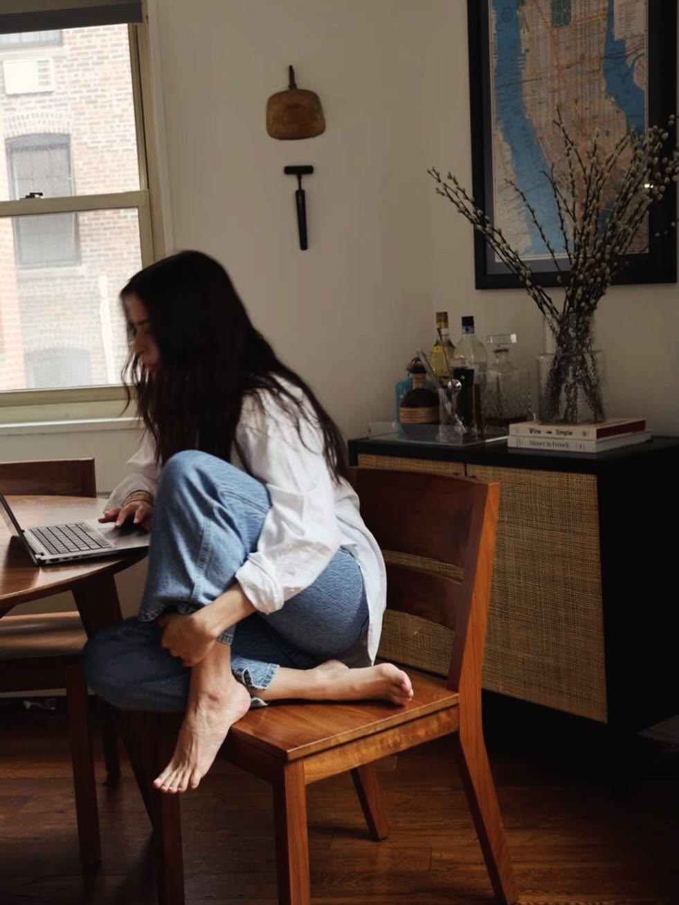 young lady sitting alone with a laptop