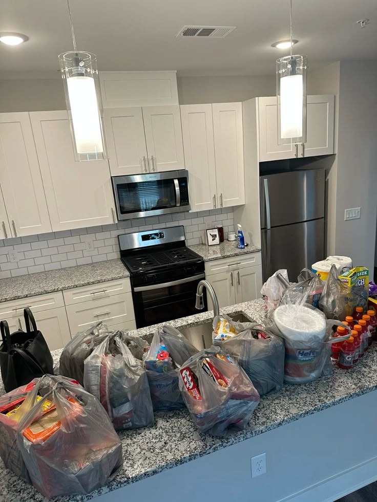 packs of groceries on the kitchen counter as regards to first apartment mistakes you’ll want to avoid.