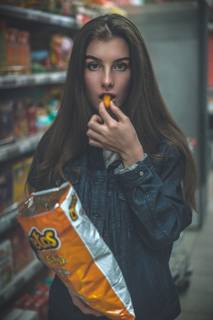 lady eating snacks at the grocery store
