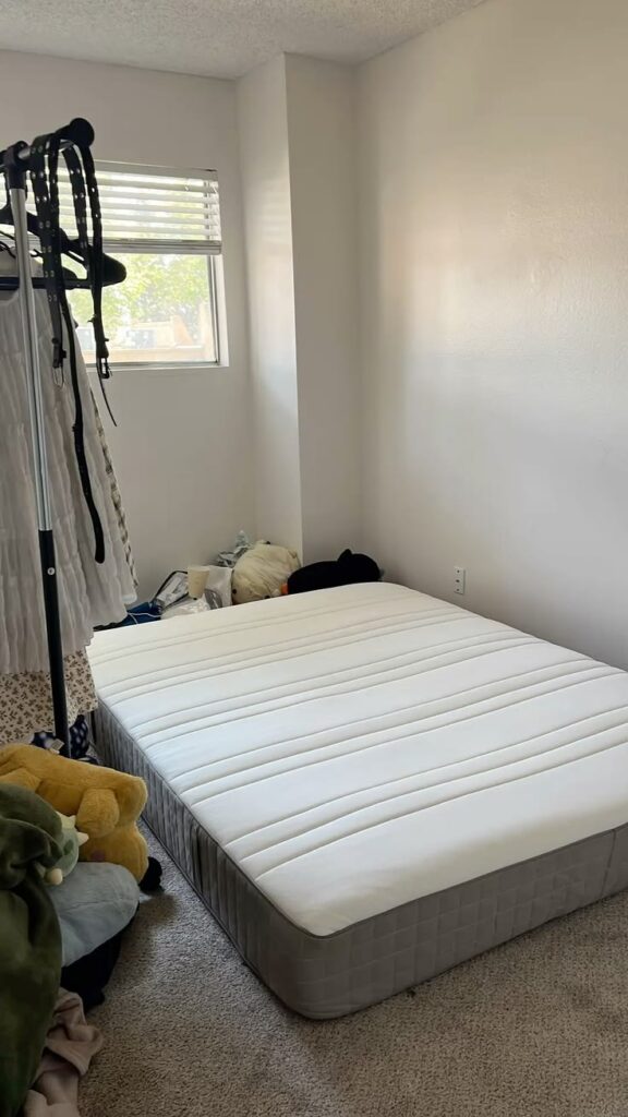 a simple mattress in an unfurnished bedroom
