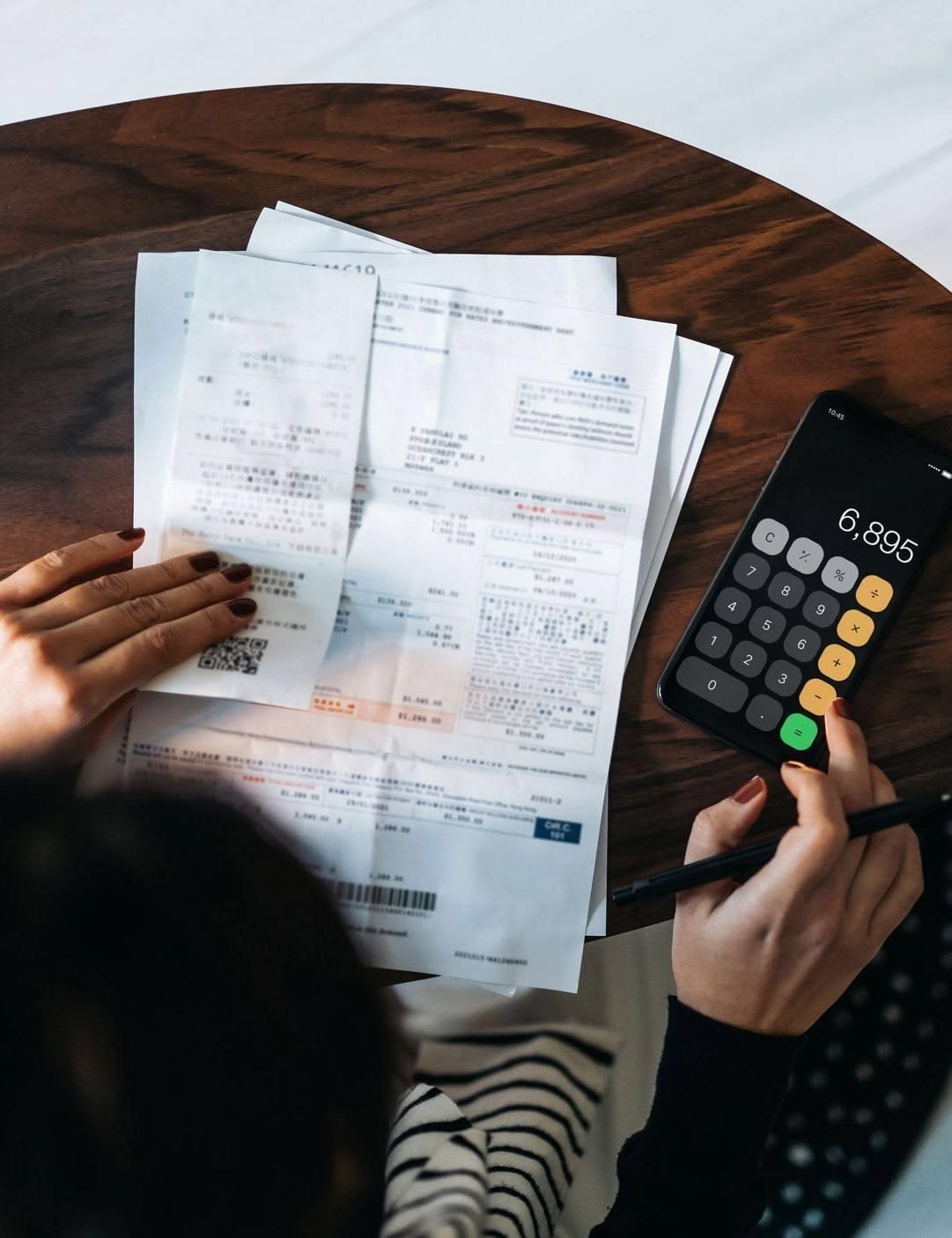 lady making a new apartment budget as regards to first apartment mistakes you’ll want to avoid 